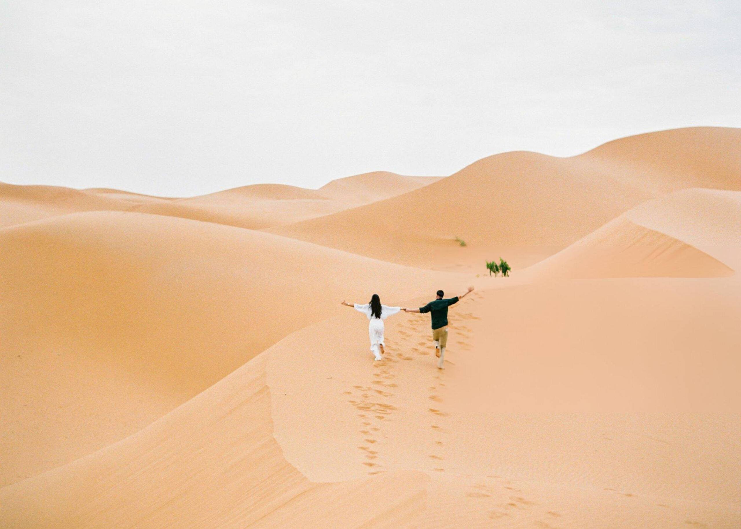 A couple enjoying a romantic sunset in Morocco during their honeymoon.